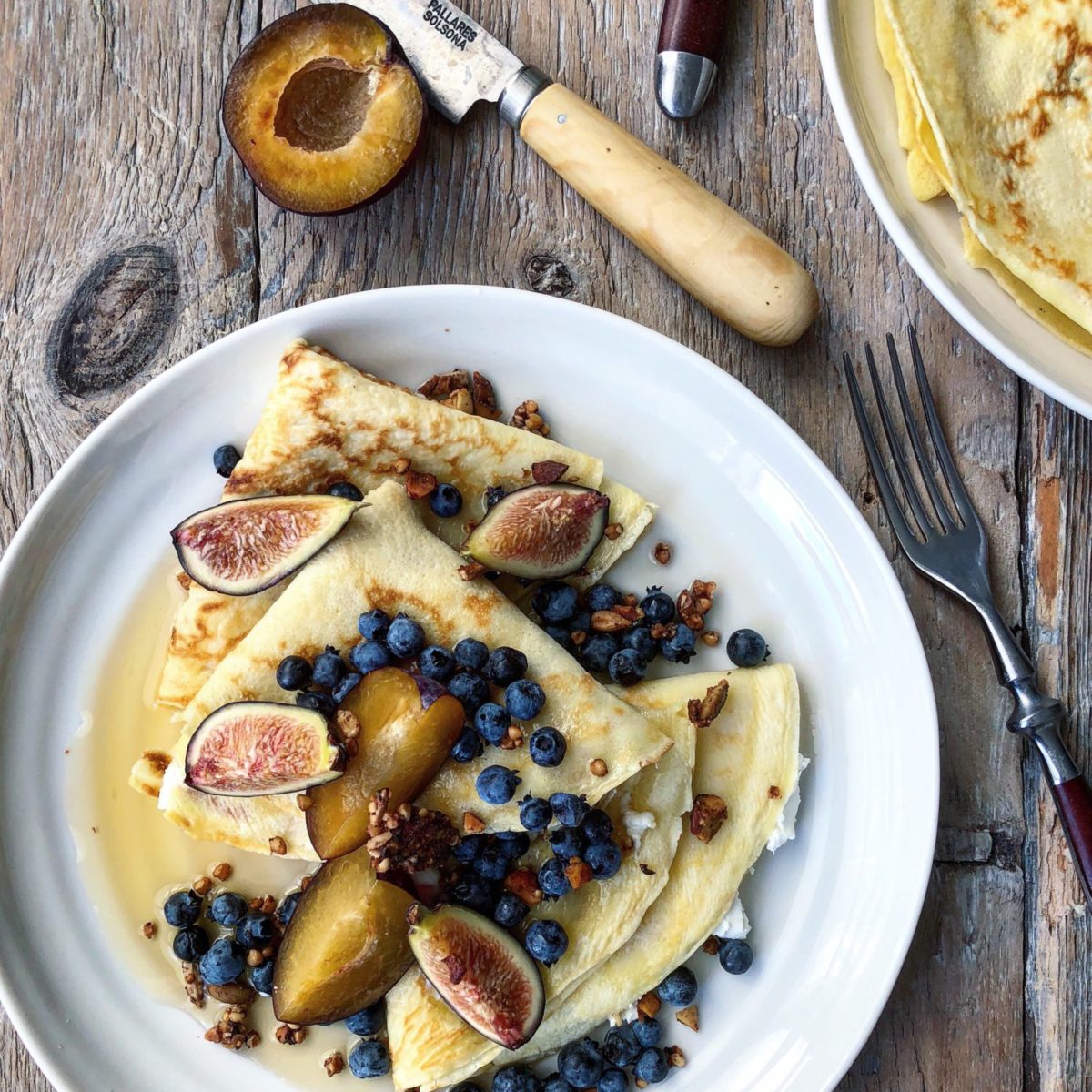 Lemon Zest Crepes stuffed with lemon zested goat cheese and topped with fresh fruit and maple syrup