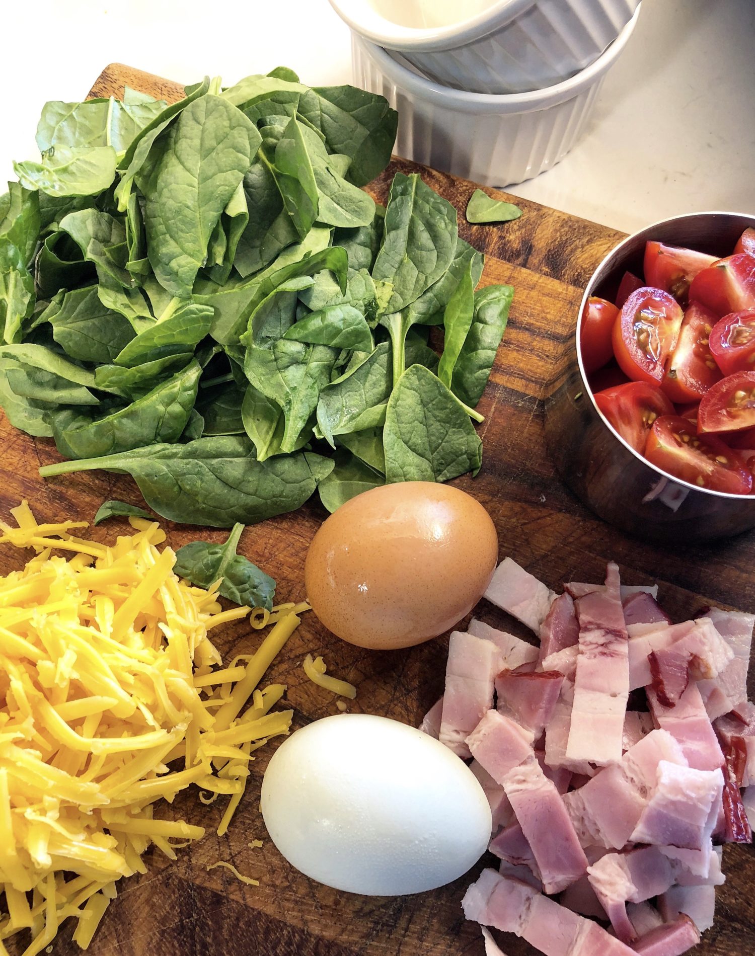 Baby Spinach, cherry tomatoes, grated cheddar cheese, eggs and double smoked bacon for Baked Eggs