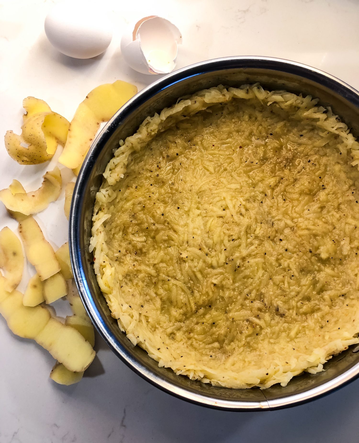 Quiche with hash brown crust before baking