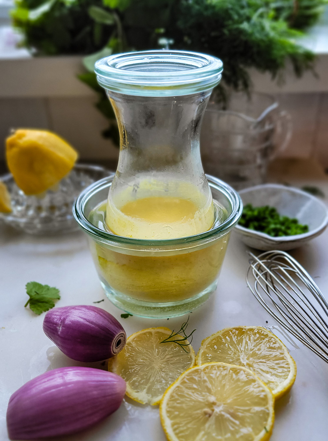 a jar of hollandaise sauce sitting in warm water to keep warm till ready to serve