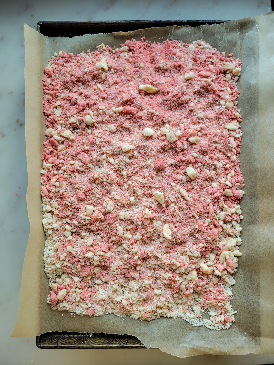 a sheetpan with strawberry shortcake crumble ready to go into the oven.