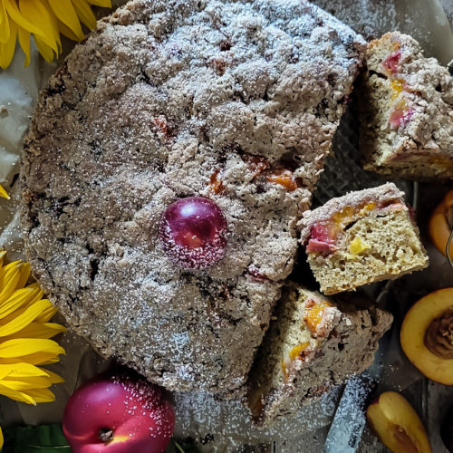 Brown Butter Stone Fruit Streusel Coffee Cake with slices on the side showing the fruit inside.