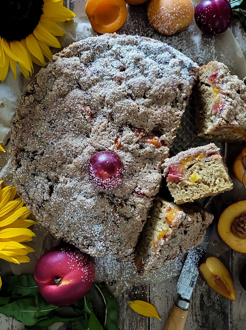 Brown Butter Stone Fruit Streusel Coffee Cake with slices on the side showing the fruit inside.