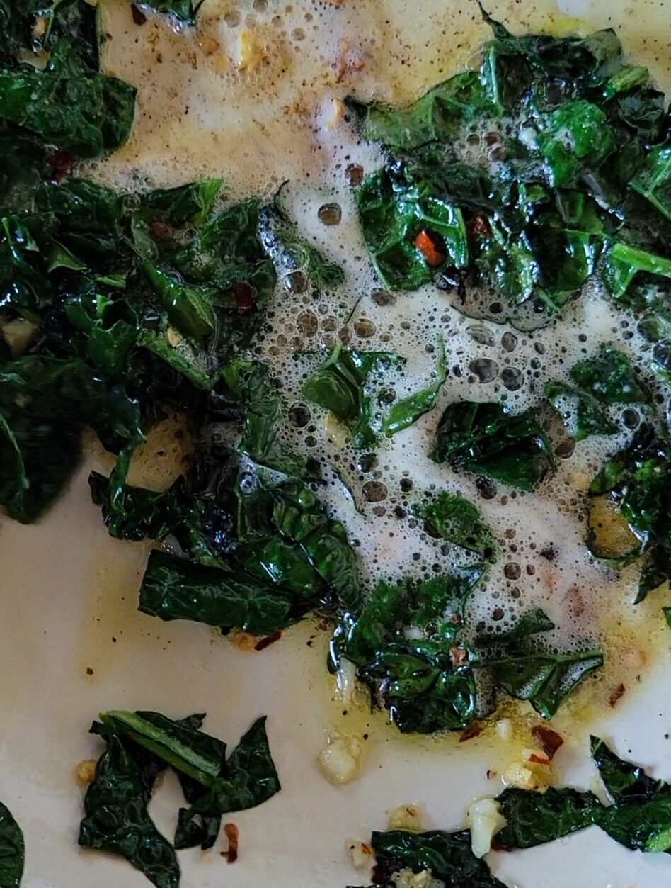 brown butter in a skillet with kale, garlic and chilli flakes added.