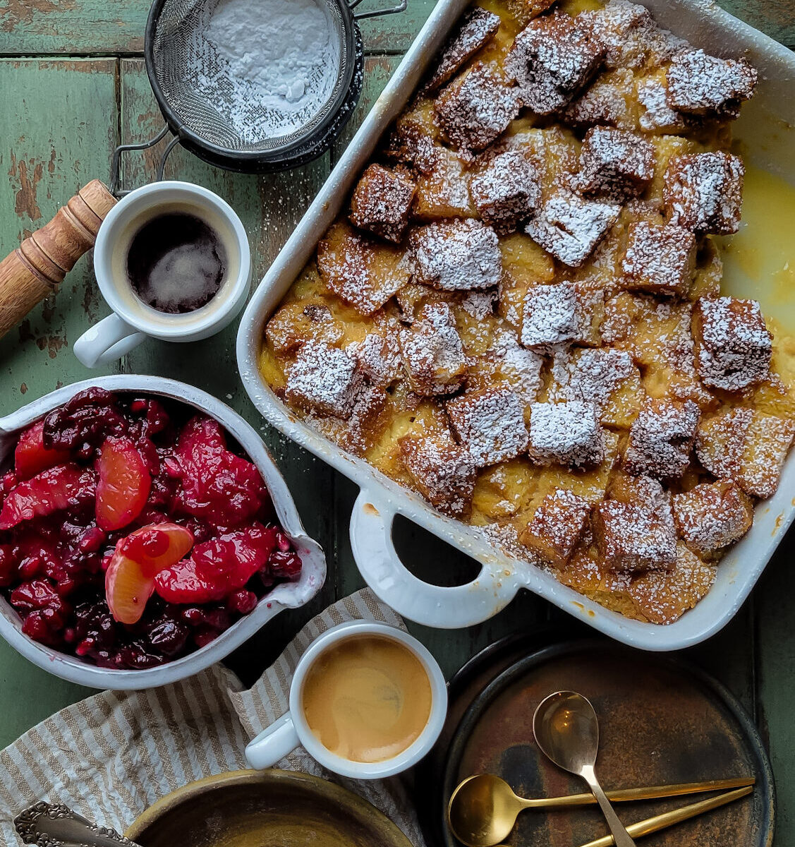 A bowl of Citrus Compote with a baking dish of Panettone Bread Pudding next to it.