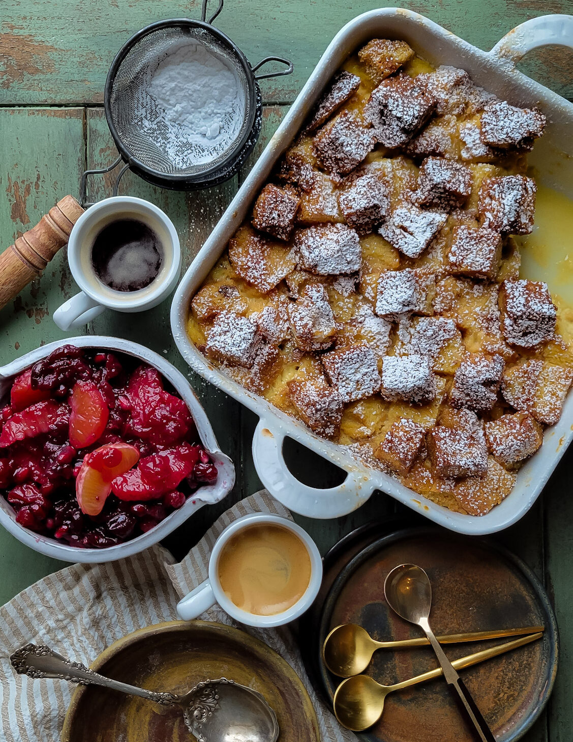 A bowl of Citrus Compote with a baking dish of Panettone Bread Pudding next to it.