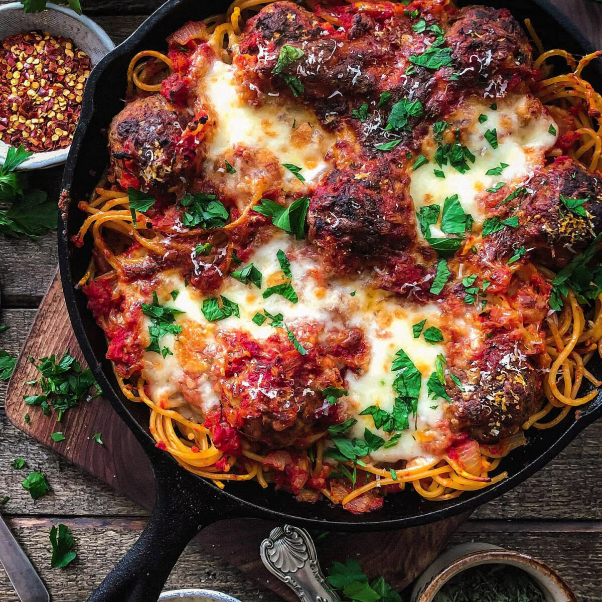 a Skillet with spaghetti and Cheesy Baked Meatballs