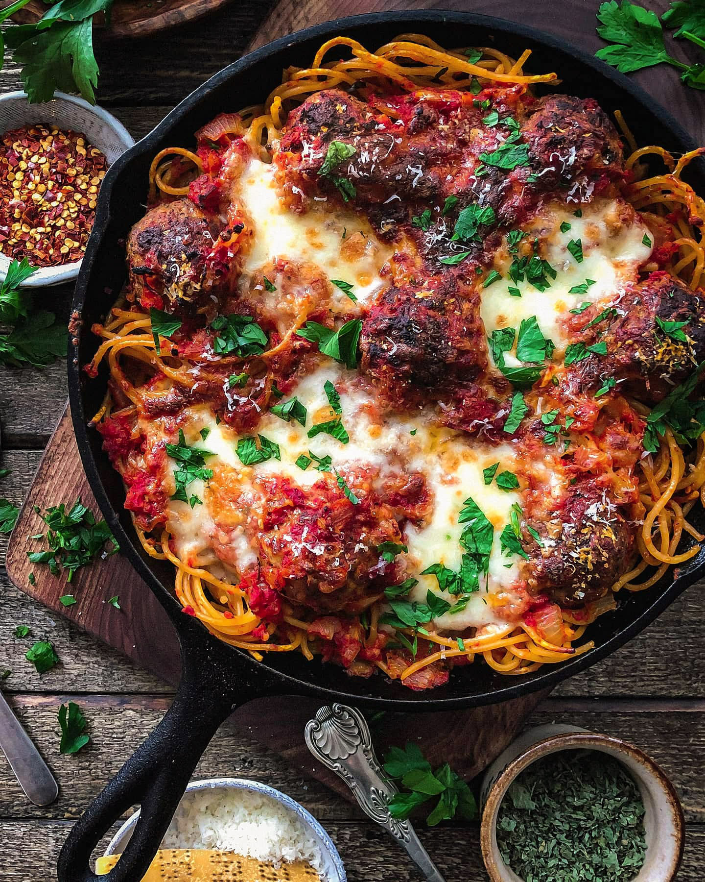 a Skillet with spaghetti and Cheesy Baked Meatballs