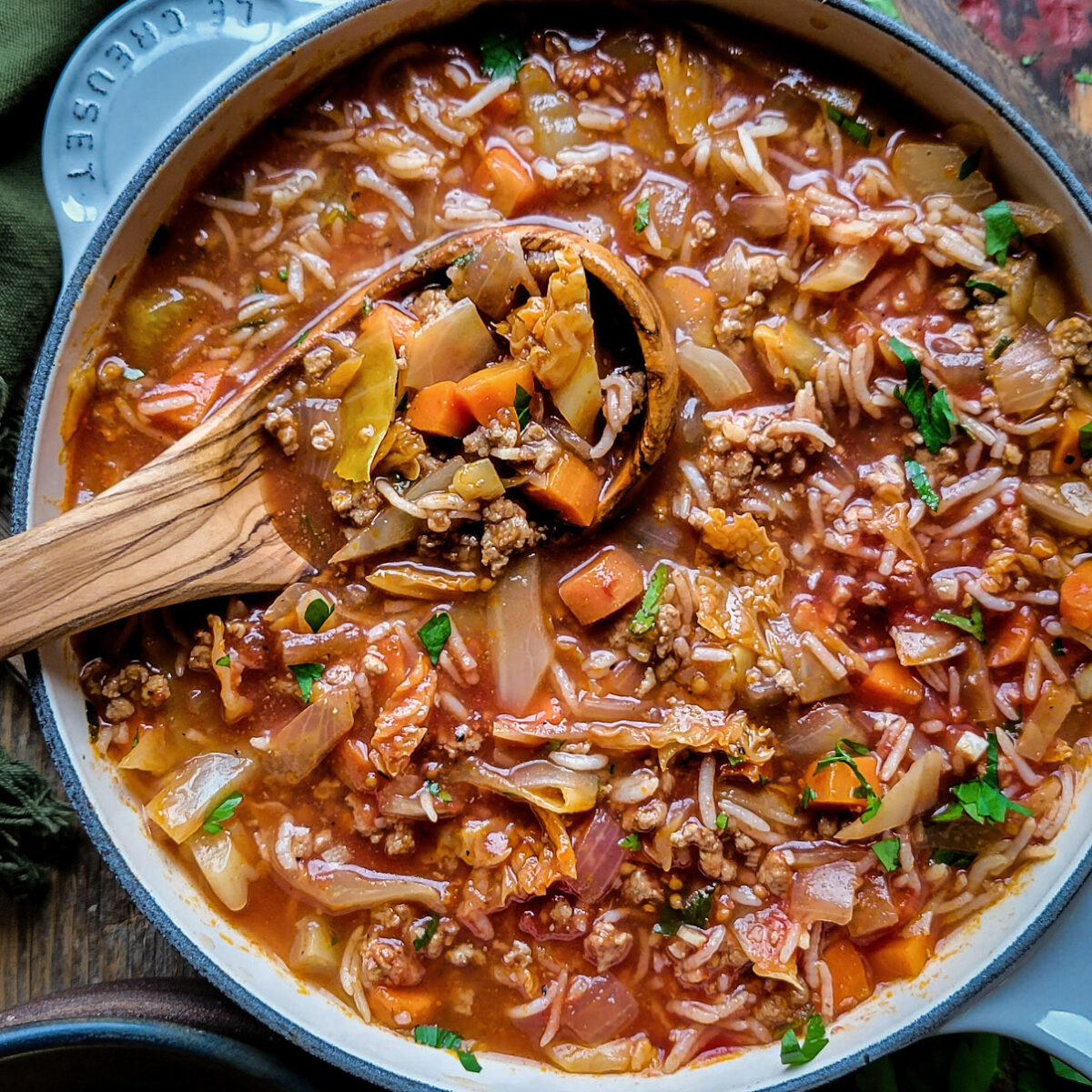 A pot of Cabbage Roll Soup with a ladle in the pot.