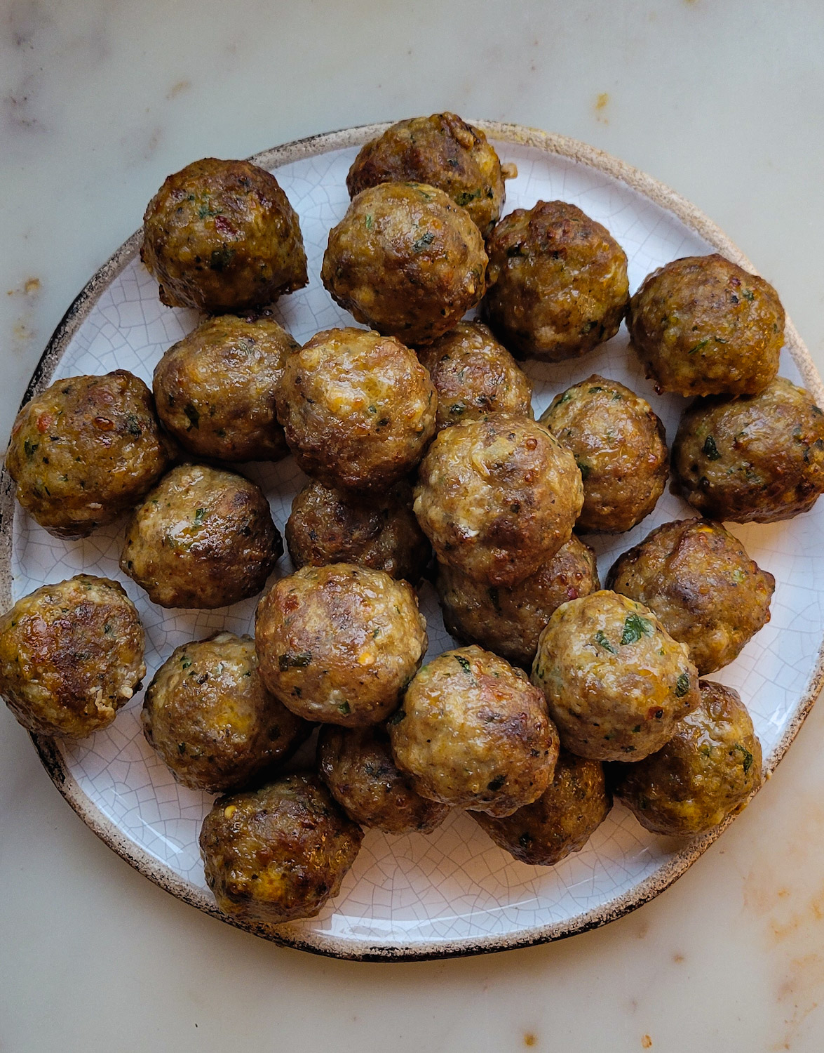 A plate of meatballs ready to be added to the pot of Meatball Soup