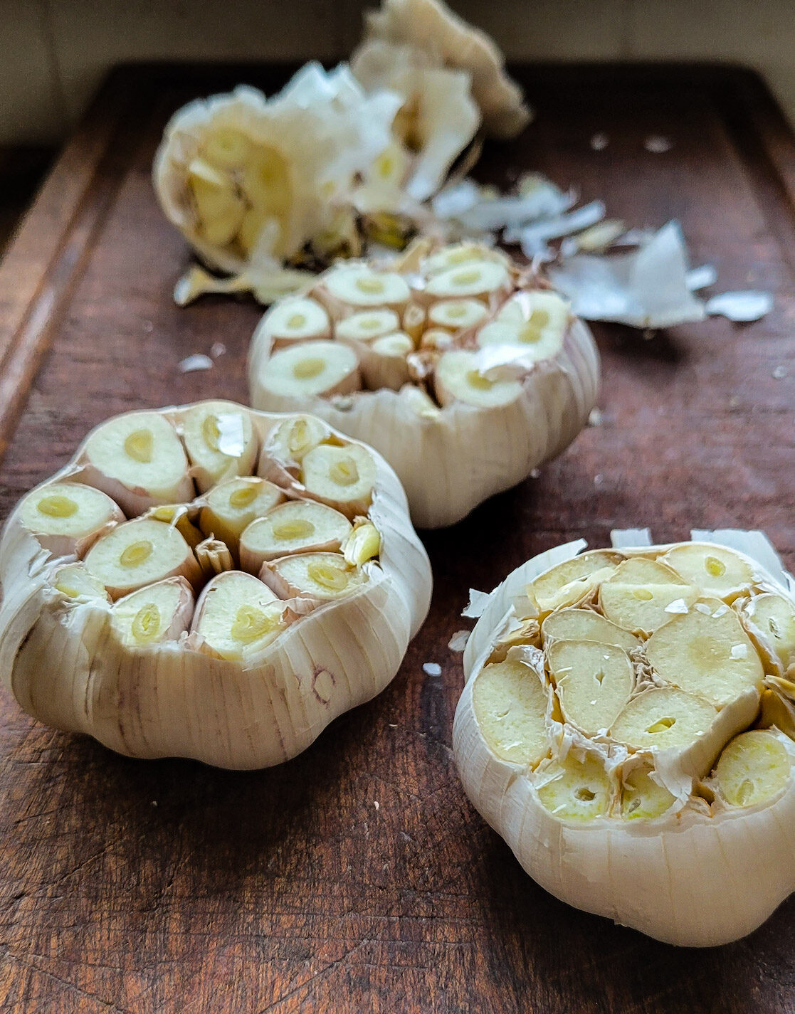 Three heads of garlic getting ready to be roasted