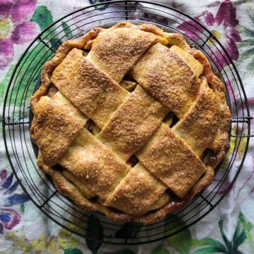 Fully baked Apple Rhubarb Pie on a cooling rack.