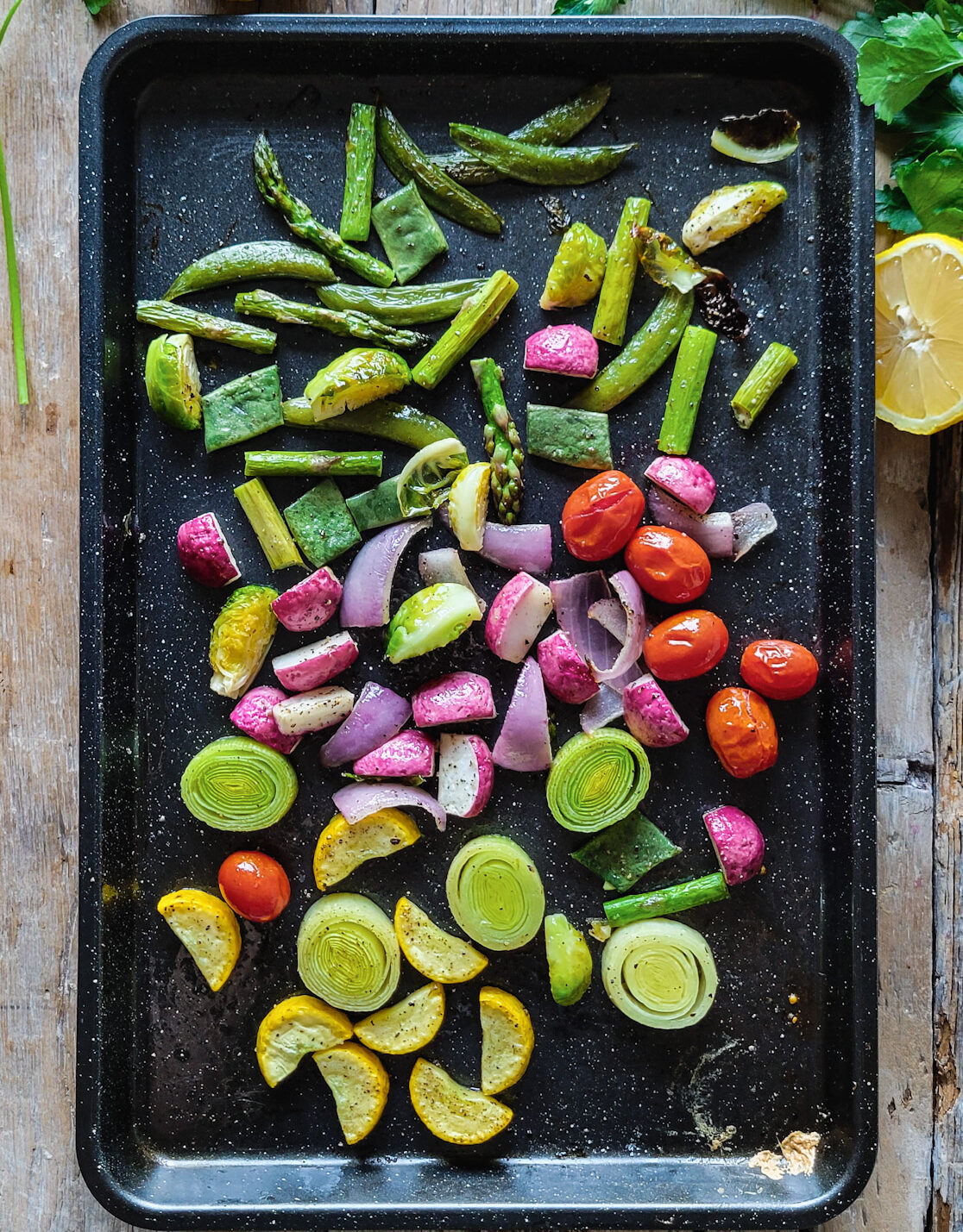 A baking tray filled with fresh roasted spring vegetables.