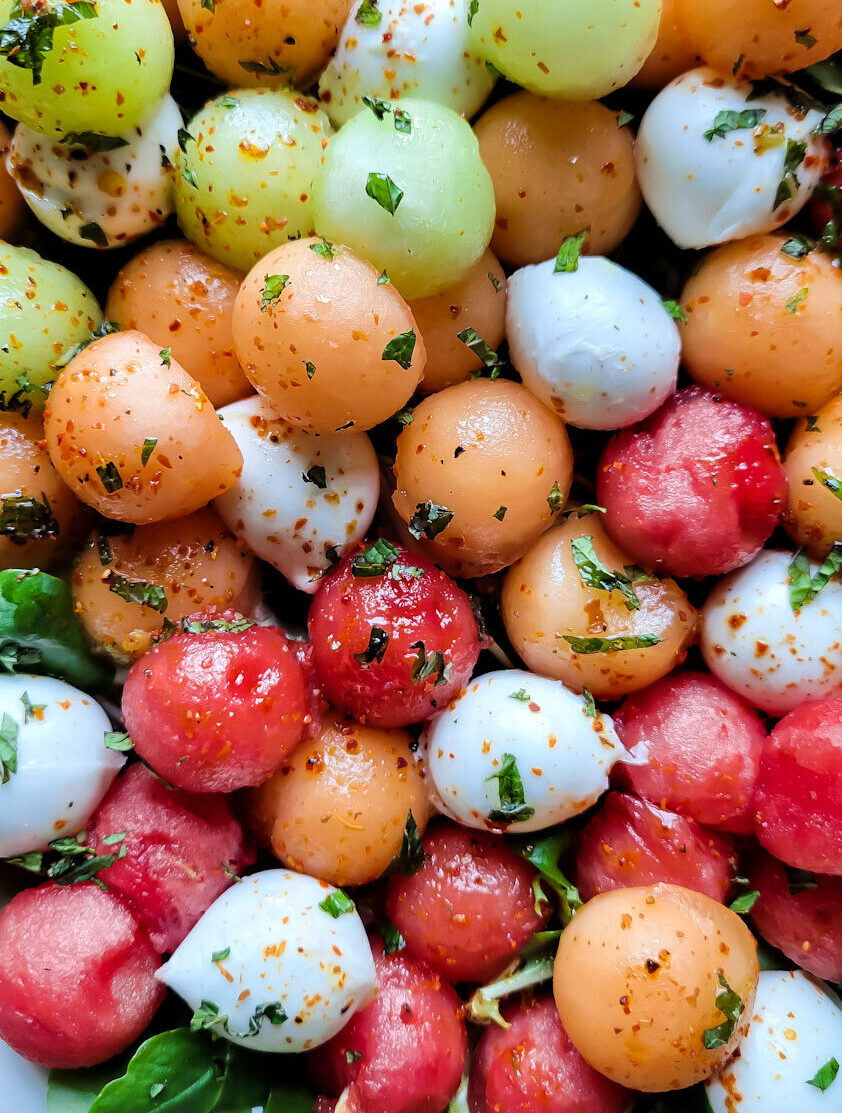 Close up of Agua Fresca Melon Salad with Mexican Tajín seasoning sprinkled over it.