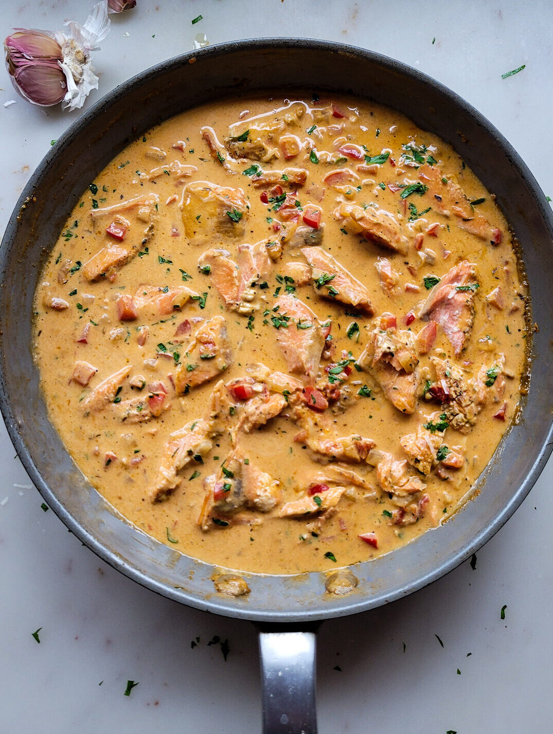 A skillet filled with Creole Cream Sauce and broken up Air Fryer Salmon.