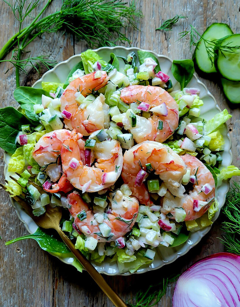 A plate of Nordic Shrimp Salad on a bed or lettuce.