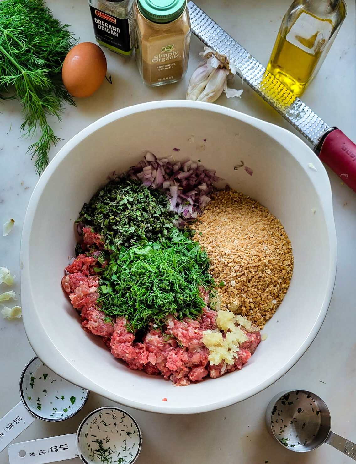 Prep of Feta Stuffed Greek Meatballs showing all the ingredients in a bowl ready to be mixed together.