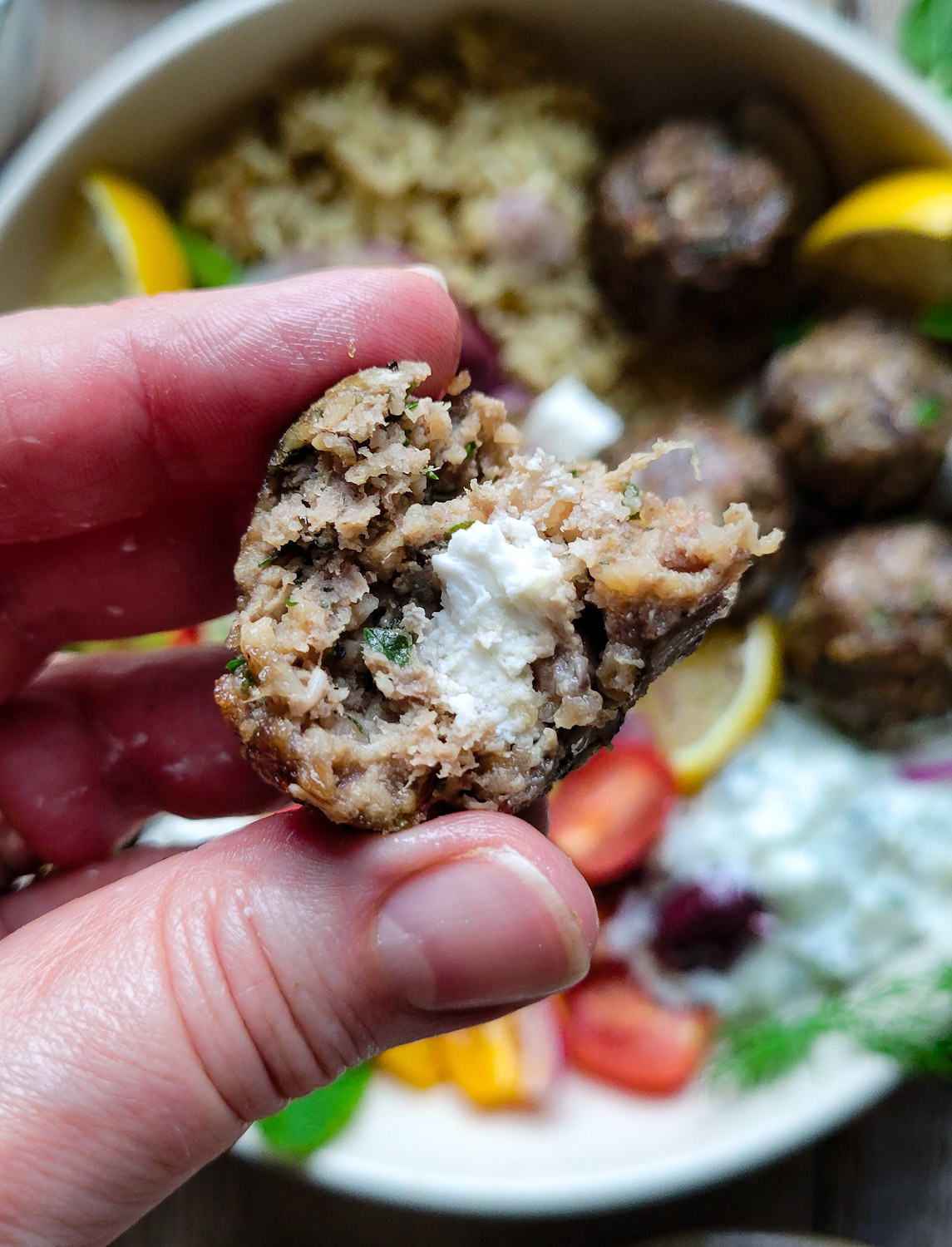Close up of the interior of a Baked Feta Stuffed Greek Meatball.