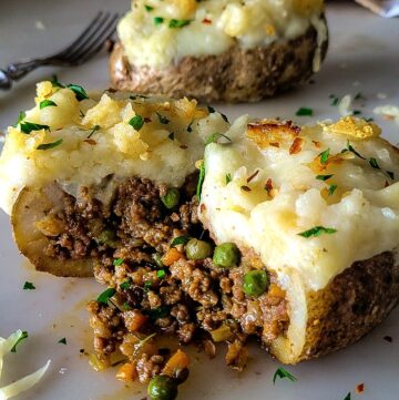 A Shepherd's PIe Stuffed Potato has been sliced open to reveal the meat and vegetable filling.