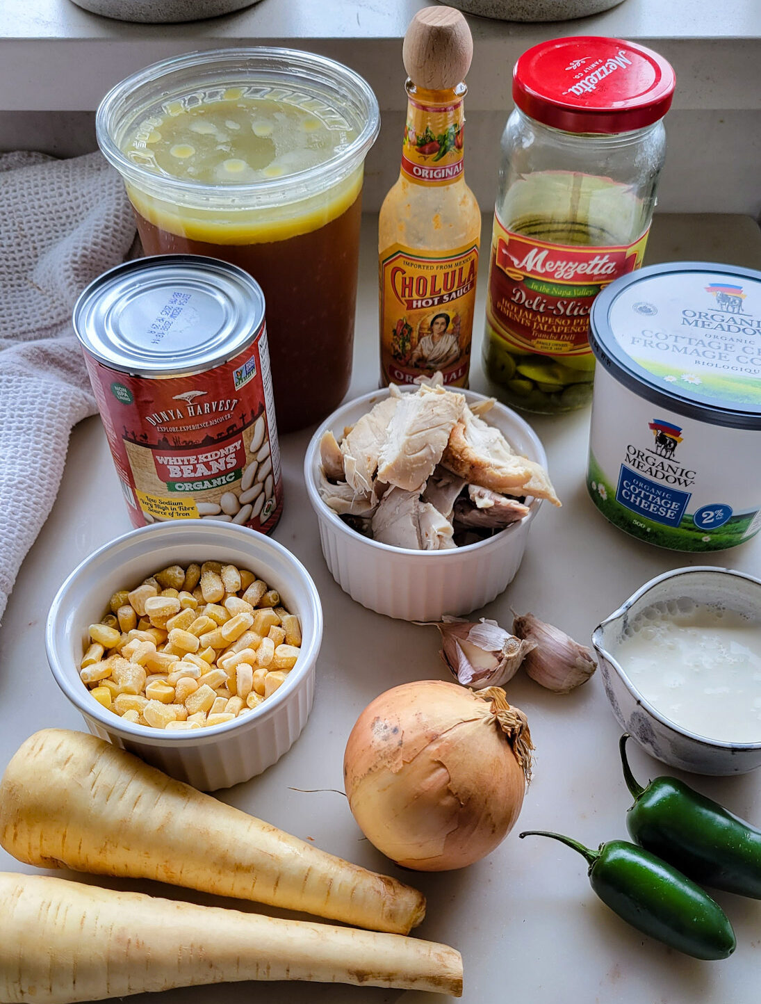 Ingredients needed to make White Creole Chicken and Bean Chilli are on the counter.