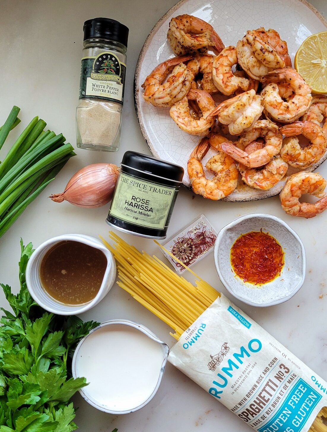 Ingredients needed for Harissa Shrimp Pasta on the counter.