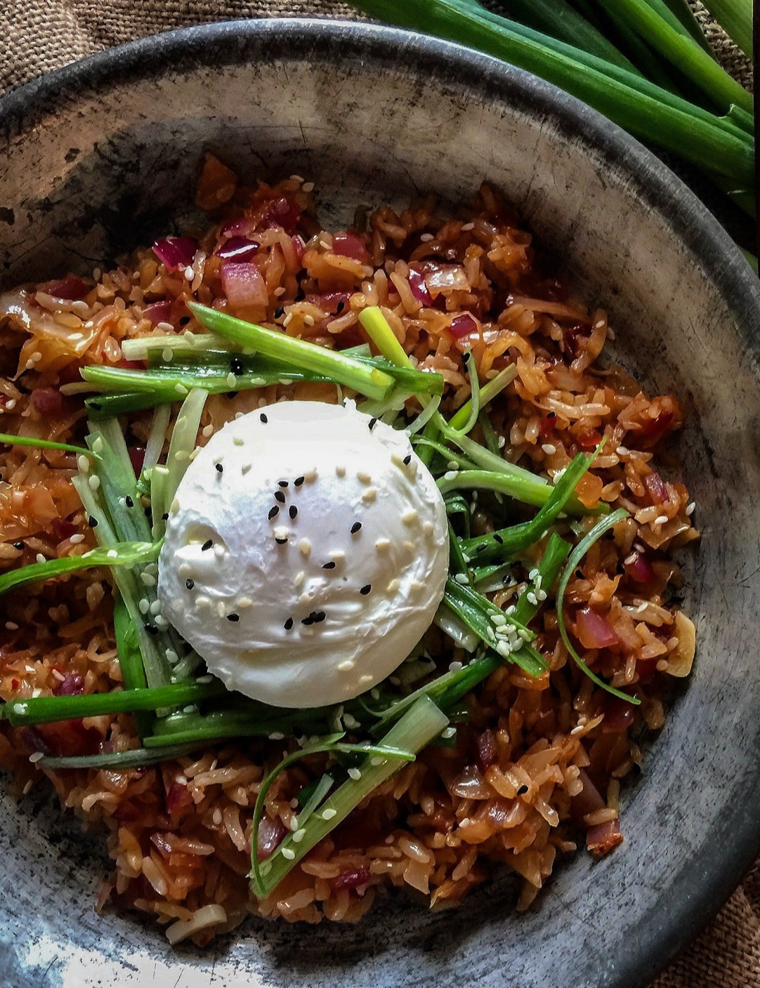 Kimchi Fried Rice topped with Scallion Salad and a poached egg.