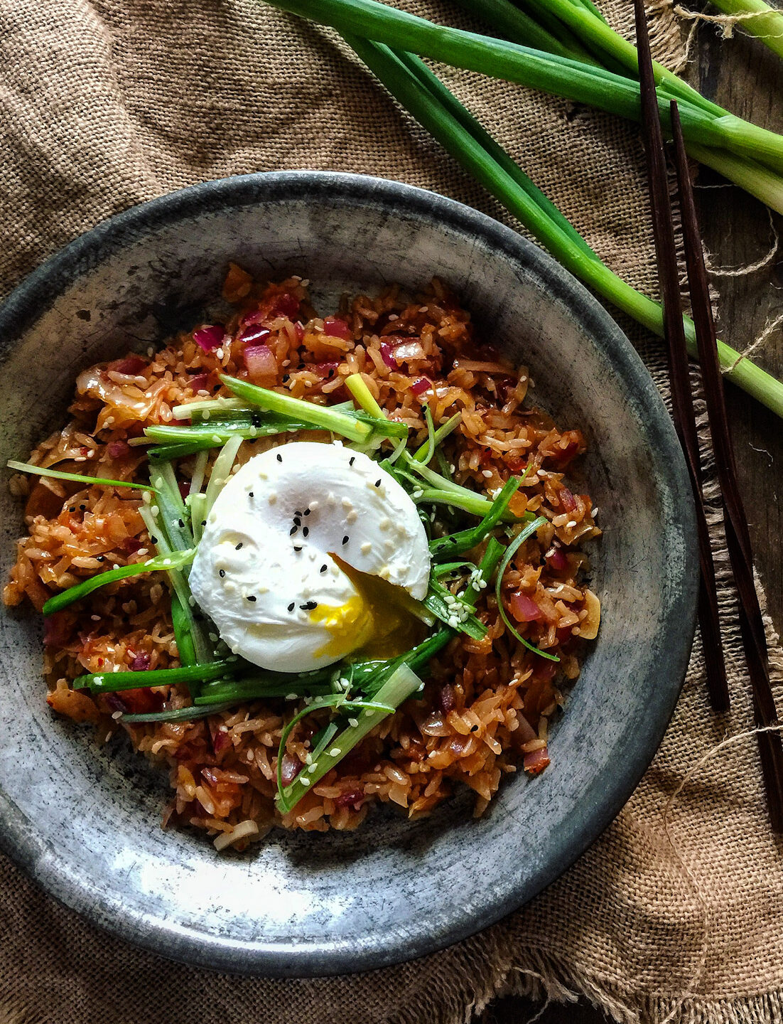 Kimchi Fried Rice topped with Scallion Salad and a poached egg.