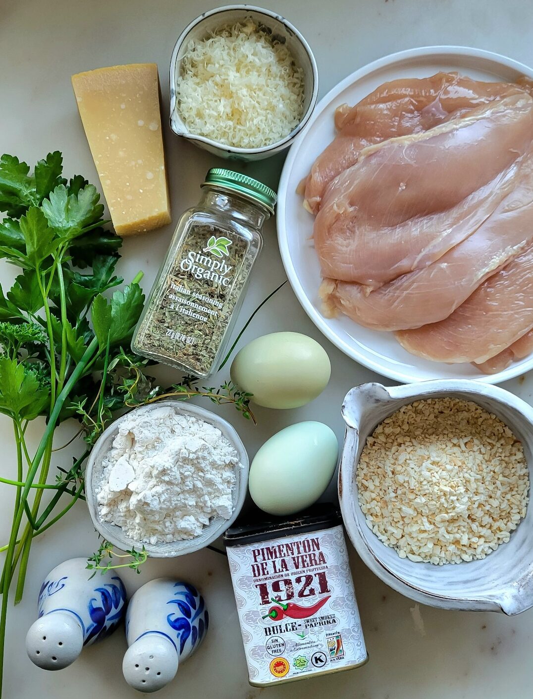 Ingredients needed to Create the Parmesan Crusted Chicken for a Caesar Pasta Salad with Chicken are spread out on the counter.