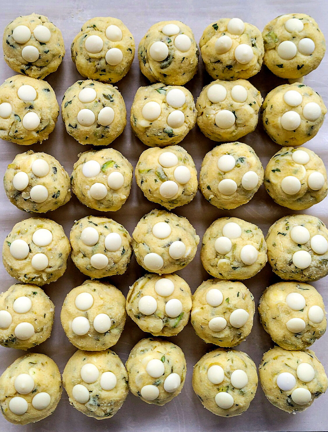 Lemon Basil Cookies with White Chocolate and Pistachios all rolled up and ready to bake.