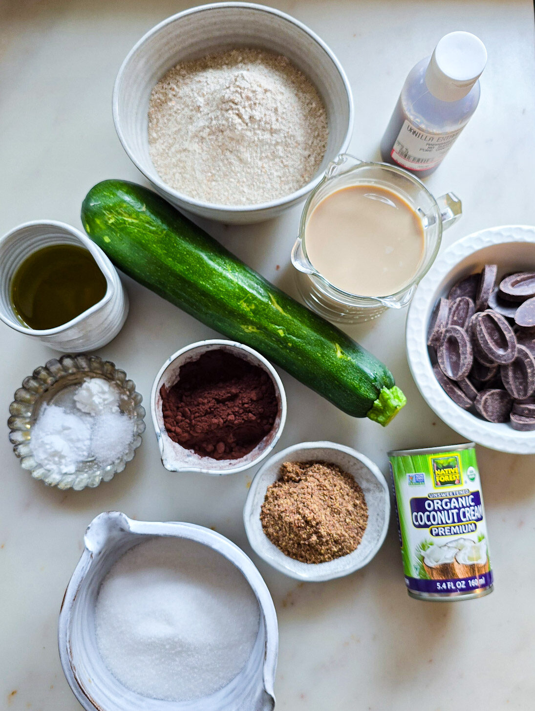 Ingredients needed to make a Double Chocolate Zucchini Cake are spread out on the counter