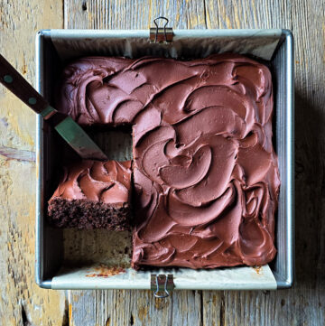 Looking down on a Double Chocolate Zucchini Cake with one slice lifted up to see the luscious interior.