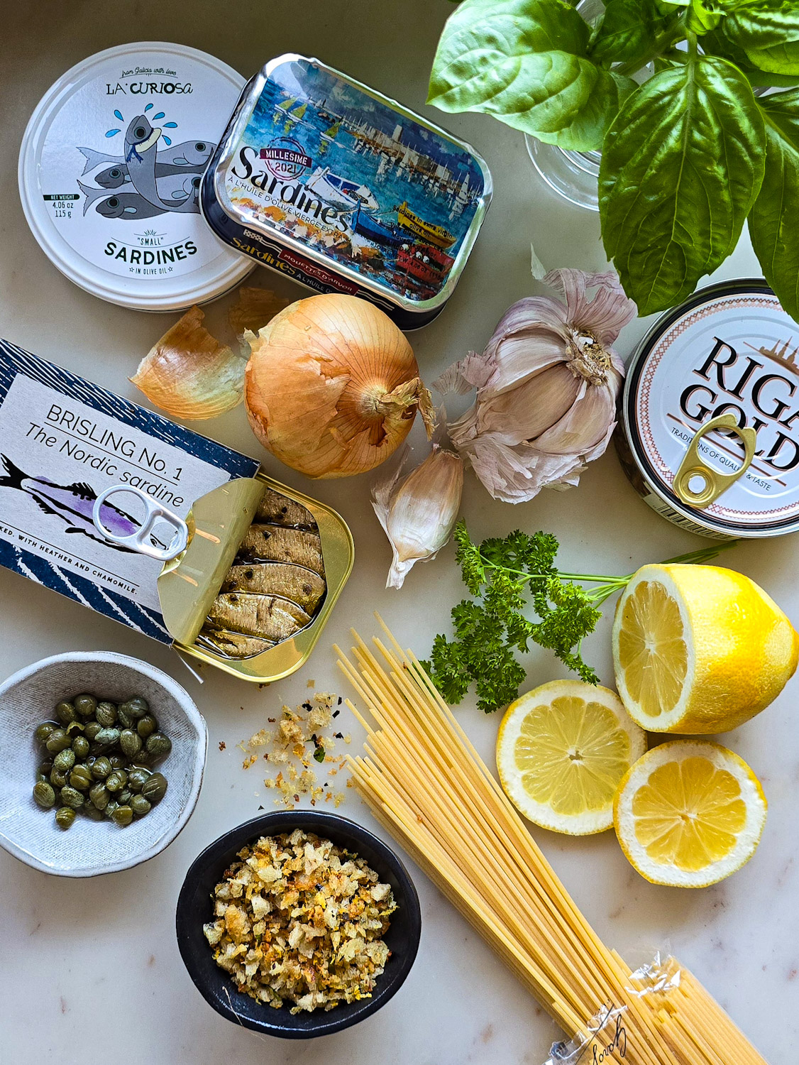 Ingredients needed to make Sardine and Lemon Pangratttato Pasta set out on the counter.