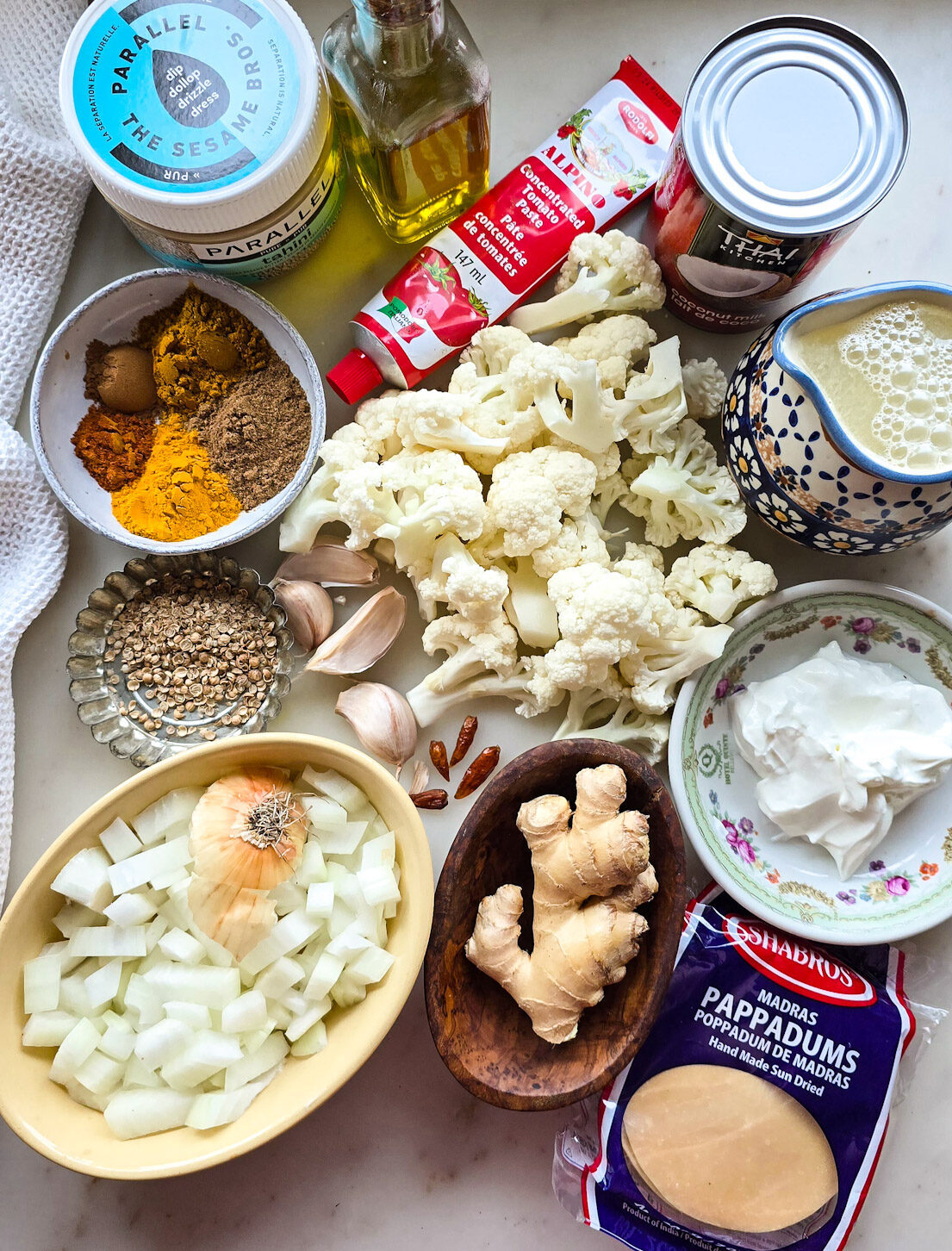 Ingredients needed to make Curry Cauliflower Soup are on the counter.