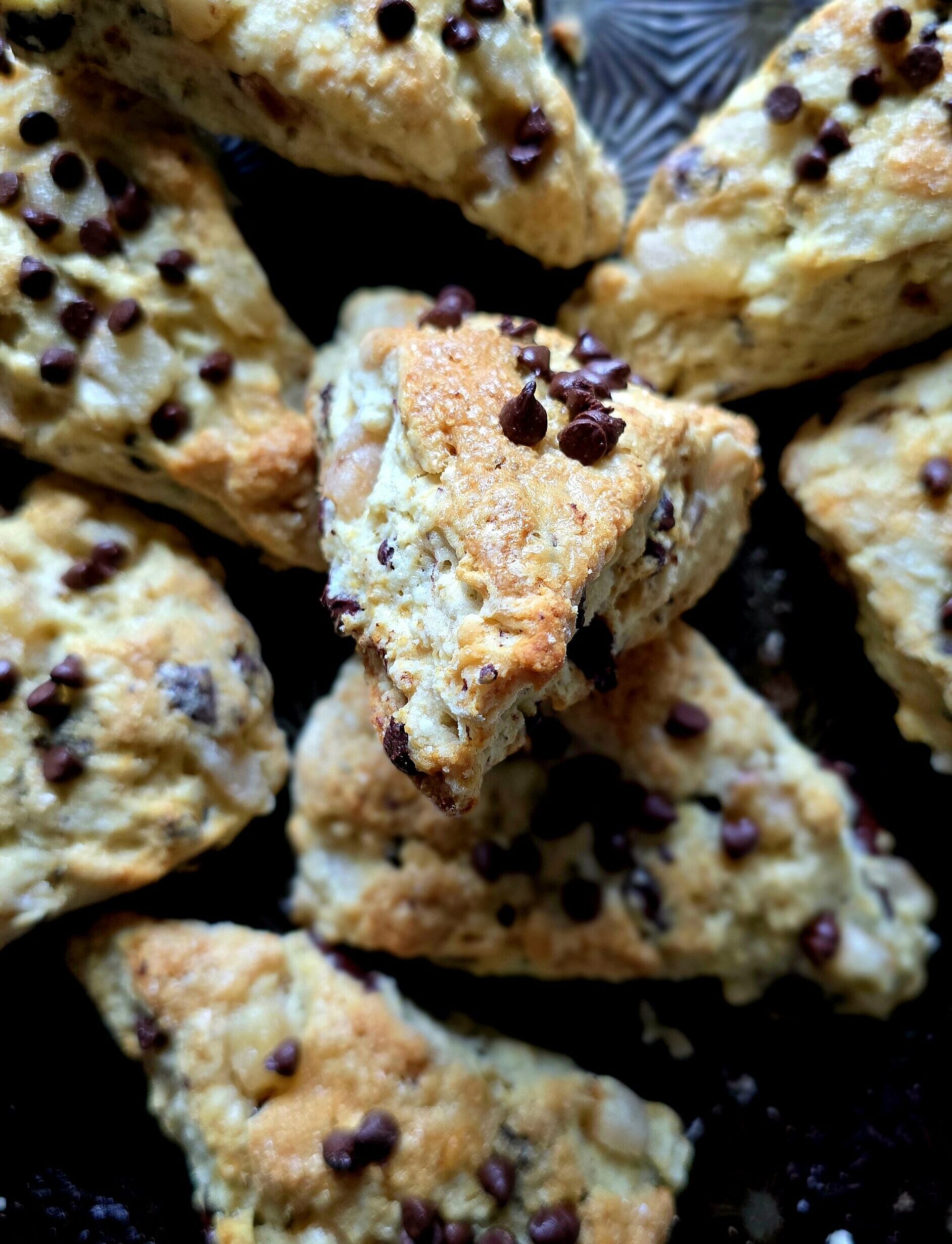 A baking sheet is loaded with freshly baked Pear and Chocolate Scones