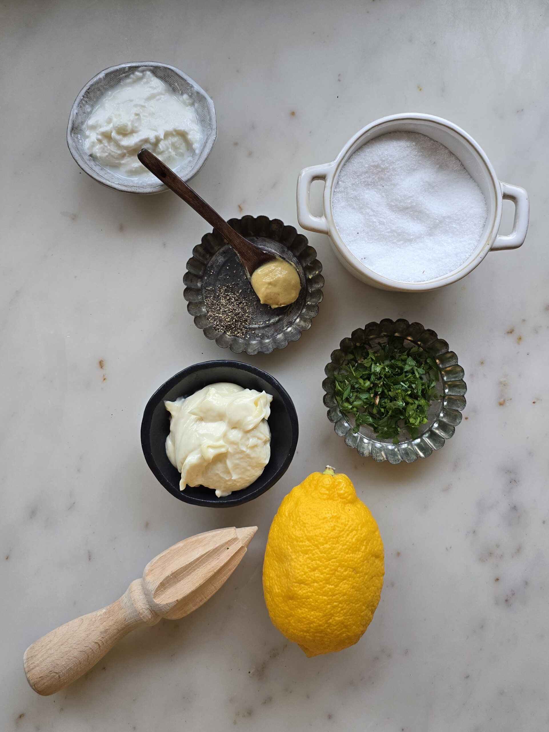 Ingredients needed to make the dressing for the Leftover Diner Turkey Salad are spread out on the counter.