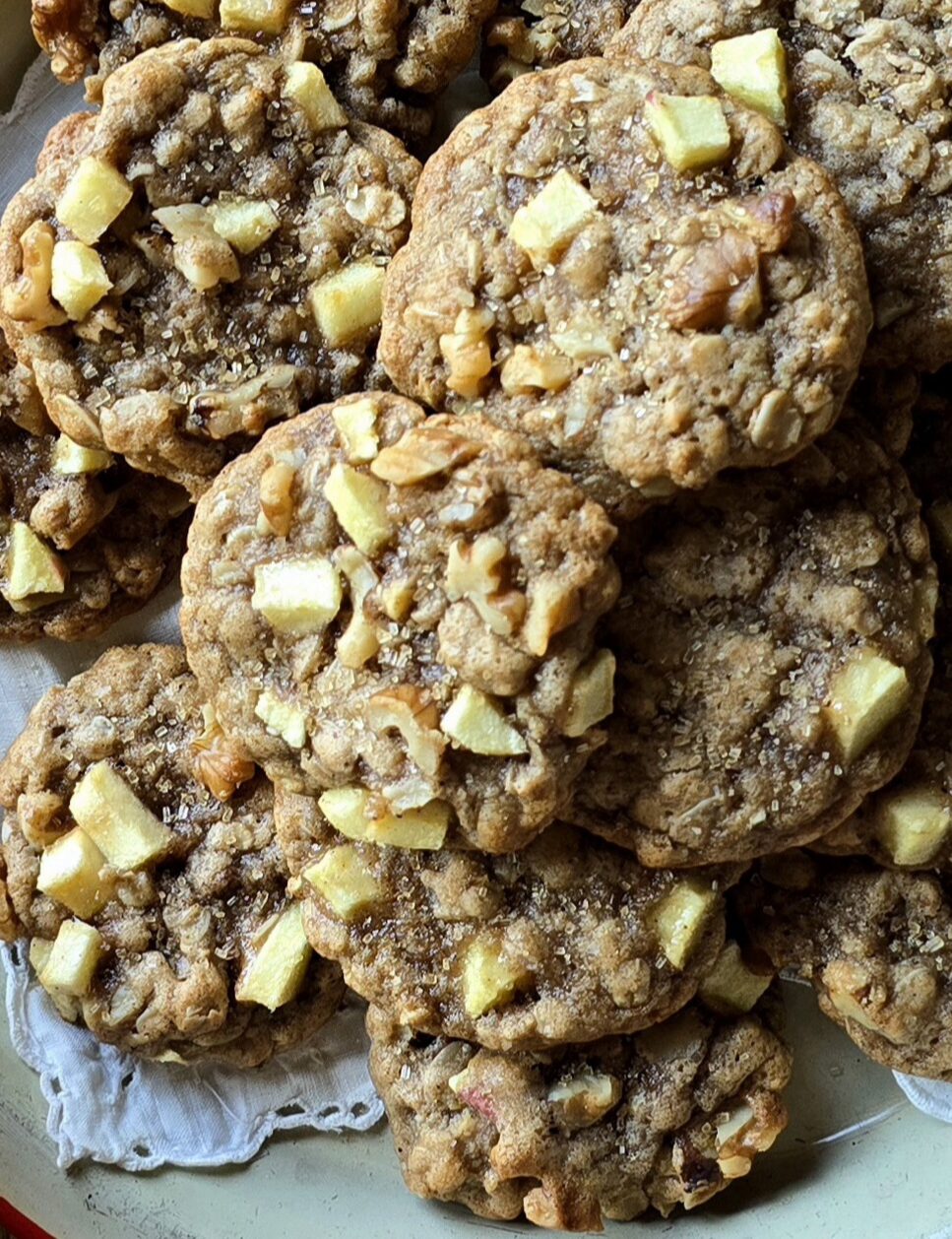 Close up of Chewy Chai Apple Oatmeal Cookies showcasing the chunks of apple, walnuts and raw sugar sprinkles.